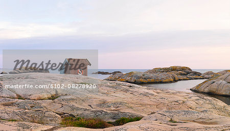 Wooden shed on rocky coast