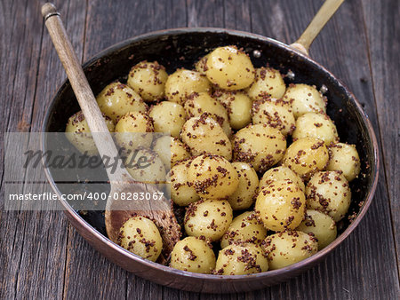 close up of rustic boiled potato in mustard