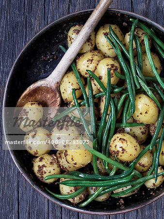 close up of rustic boiled potato in mustard and bean