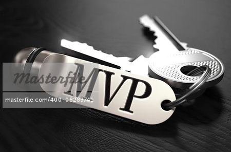 MVP - Most Valuable Player - Concept. Keys with Keyring on Black Wooden Table. Closeup View, Selective Focus, 3D Render. Black and White Image.