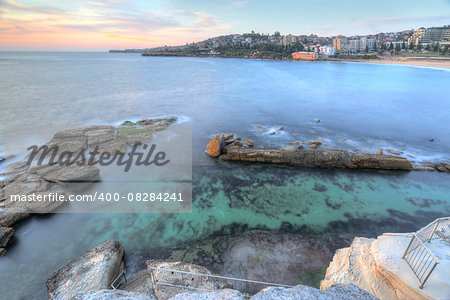 High views from the cliff top overlooking the northern rockpool at Coogee in Sydney's eastern suburbs.  Giles Baths is a natural rock pool, known as the Bogey hole  and beyond are its three southern rock pools