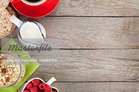 Healthy breakfast with muesli, berries and milk. On wooden table with copy space