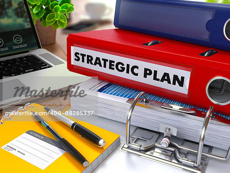 Red Ring Binder with Inscription Strategic Plan on Background of Working Table with Office Supplies, Laptop, Reports. Toned Illustration. Business Concept on Blurred Background.