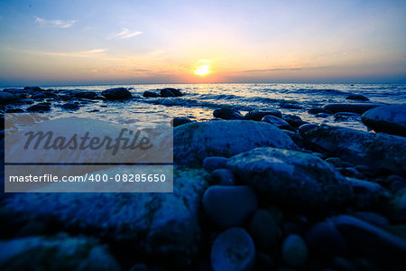 Amazing Sunset over the coast of pebble sea