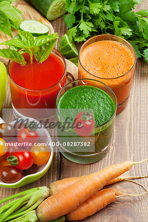Fresh vegetable smoothie on wooden table. Tomato, cucumber, carrot