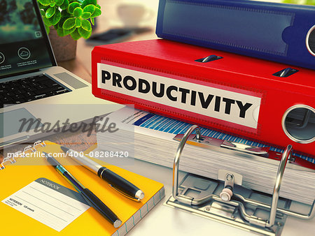 Red Office Folder with Inscription Productivity on Office Desktop with Office Supplies and Modern Laptop. Business Concept on Blurred Background. Toned Image.
