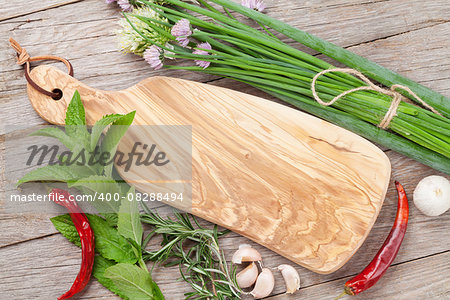 Fresh herbs and spices on wooden table. Top view with copy space