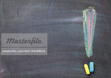 Colorful chalk exclamation mark on blackboard background with copy space