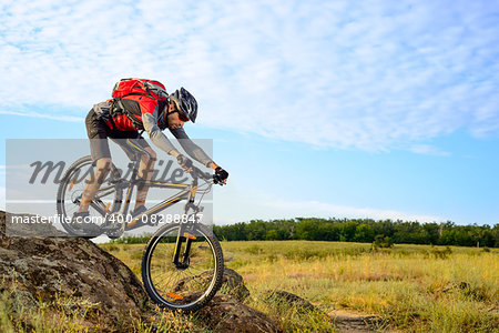 Cyclist Riding the Bike Down Rocky Hill. Extreme Sport Concept.