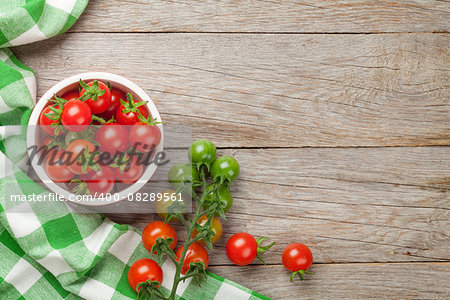 Cherry tomatoes on wooden table. Top view with copy space