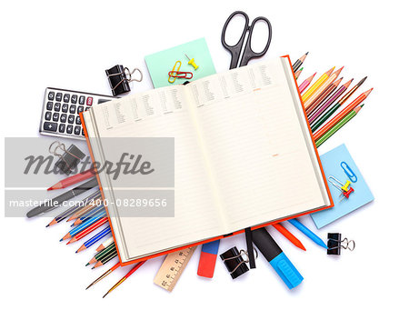 Blank notepad over school and office supplies on office table. Isolated on white background. Top view with copy space