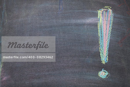 Colorful chalk exclamation mark on blackboard background with copy space