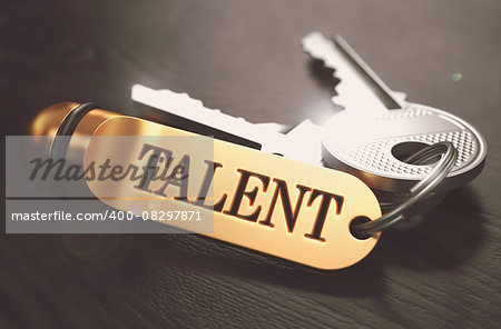 Keys and Golden Keyring with the Word Talent over Black Wooden Table with Blur Effect. Toned Image.