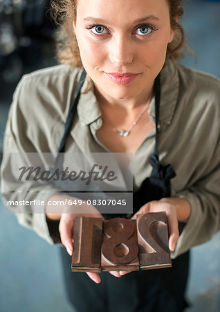 Woman holding traditional letterpress numerals workshop