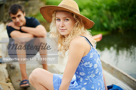 Portrait of young couple in rowing boat on river