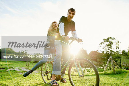 Portrait of young couple on bicycle