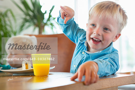 Boy and toddler brother at tea table