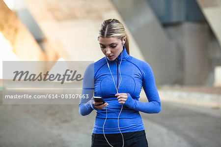 Jogger selecting music on smartphone