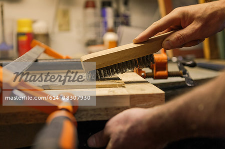 Wood artist working in workshop, close-up