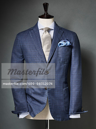 Blue colored suit with tie and handkerchief on bust in studio Blue colored suit with tie and handkerchief on bust in studio