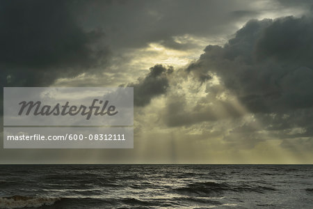 Sun Breaks through Storm Clouds over Ocean, Newell Beach, Newell, Queensland, Australia