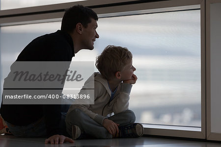 excited family of two spending time at the airport before airplane departure