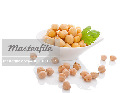Chickpeas in white bowl isolated on white background with reflection. Healthy legume eating.