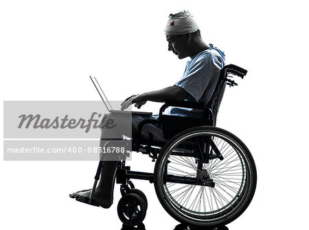 one injured man in wheelchair in silhouette studio on white background