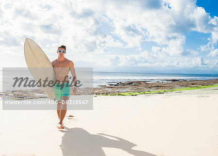 professional surfer holding a surf board man