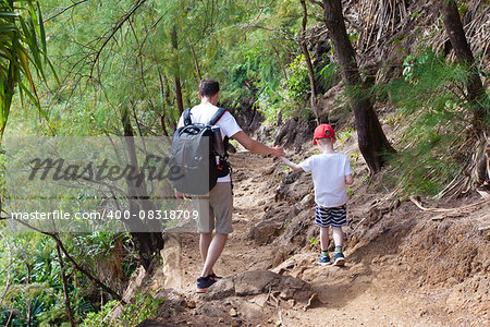 family of two hiking together the kalalau trail at kauai island, hawaii