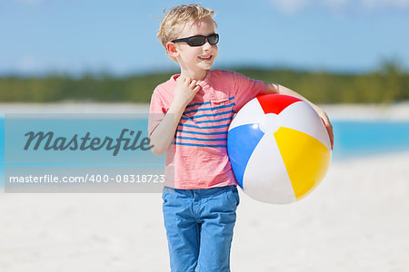 little boy with beach ball enjoying tropical vacation at bahamas