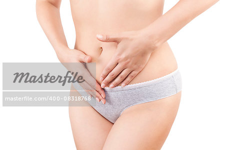 Slim belly. Beautiful woman touching her belly in grey panties isolated on white background. Menstruation, period, pregnancy and weight loss. Feminine body.