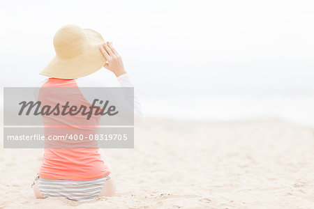 young woman in rashguard at the beach, sun or skin or uv protection concept