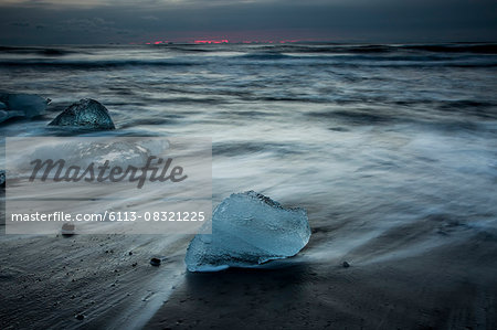 Ice on stormy cold ocean beach, Iceland