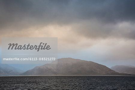 Stormy sky over craggy mountains and bay, Port Appin, Argyll Scotland