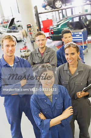 Portrait smiling mechanics in auto repair shop Portrait smiling mechanics in auto repair shop
