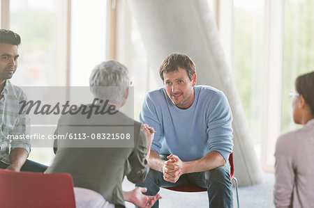 Business people talking in group meeting Business people talking in group meeting