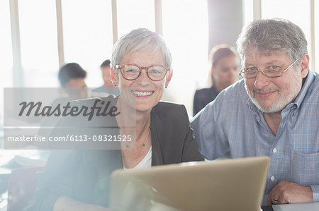 Portrait confident senior woman at laptop in adult education classroom