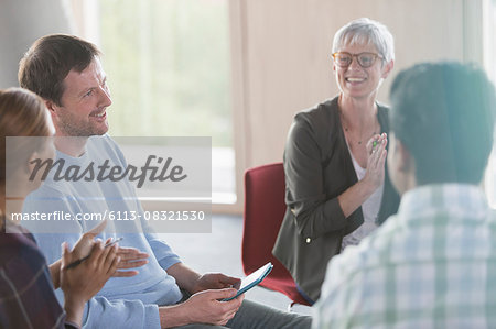 Smiling business people talking in meeting