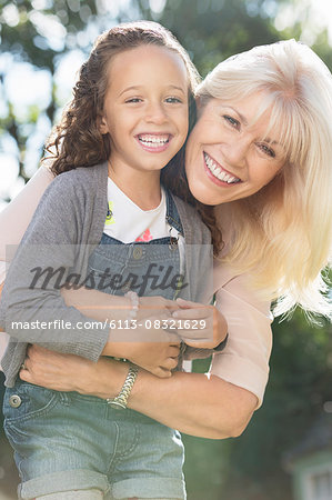 Portrait smiling grandmother and granddaughter hugging