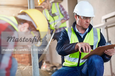 Foreman with clipboard at construction site