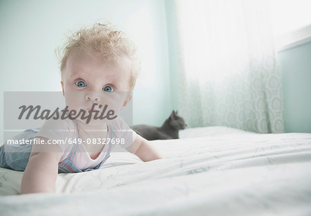 Portrait of baby girl lying on front