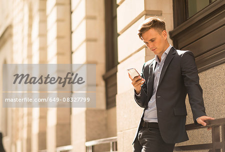 Businessman using phone, London, UK