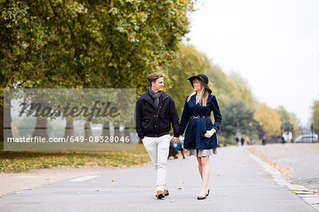 Romantic young couple strolling in park, London, England, UK