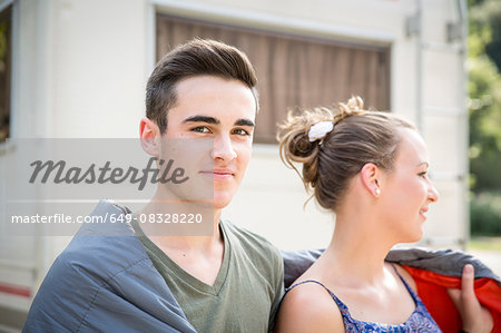 Young couple wrapped in blanket, outdoors