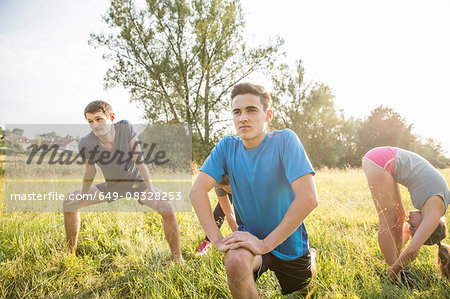 Group of friends exercising in field