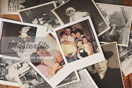 Pile of family photographs on table, overhead view