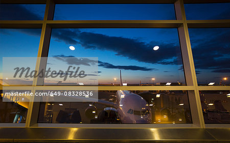 Airport terminal window view of airplane, New York, USA