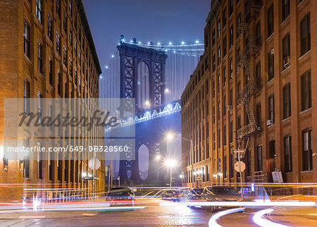 Manhattan Bridge and city apartments at night, New York, USA