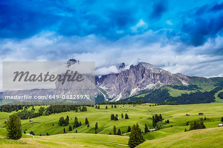 Fields and distant rock formation, Dolomites, Italy